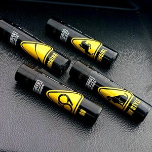 May include: Four black lighters with yellow warning signs and black text. The lighters feature different designs, including "Cowgirl", "69", "Doonin", and "Dirty Style".