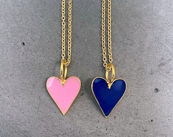 May include: Two gold chains with heart-shaped pendants. One pendant is pink enamel and the other is blue enamel.