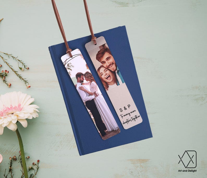 May include: Two personalized bookmarks with a photo of a couple and the text "S&P To many more chapters together". The bookmarks are brown leather with a white background.