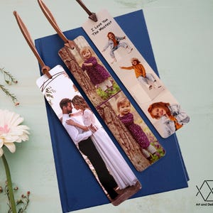 May include: Three photo bookmarks with brown leather straps. The bookmarks feature different photos of people and the text "I Love You The Mostest".