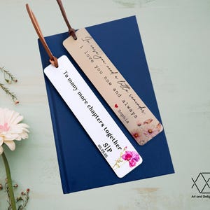 May include: Two bookmarks with floral designs and personalized messages. The first bookmark reads "In case you need a little reminder I love you now and always Sophia". The second bookmark reads "To many more chapters together S/P 02.25.25".