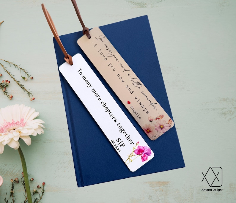 May include: Two bookmarks with floral designs and personalized messages. The first bookmark reads "In case you need a little reminder I love you now and always Sophia". The second bookmark reads "To many more chapters together S/P 02.25.25".