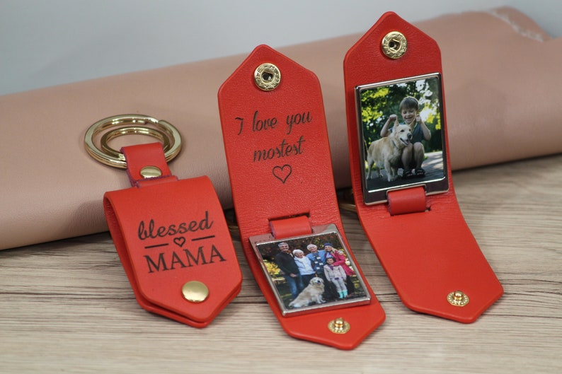 May include: Red leather keychains with gold hardware. One keychain says "blessed MAMA". Two keychains have a photo inside and the text "I love you mostest". The keychains are personalized gifts.