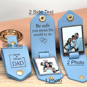 May include: Light blue leather keychain with a gold-colored ring. The keychain has a rectangular photo frame and the text "Be safe you mean the world to us." The other side says "Carols & Olivia's DAD".