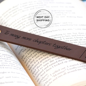 May include: A brown leather bookmark with the text "To many more chapters together" and the initials "S&P" and the date "02.25.2021" engraved on it.
