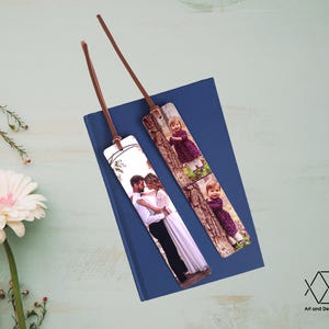 May include: Two personalized bookmarks with photos printed on them. One bookmark features a couple in a forest setting, while the other bookmark features a young girl in a purple dress in a forest setting.