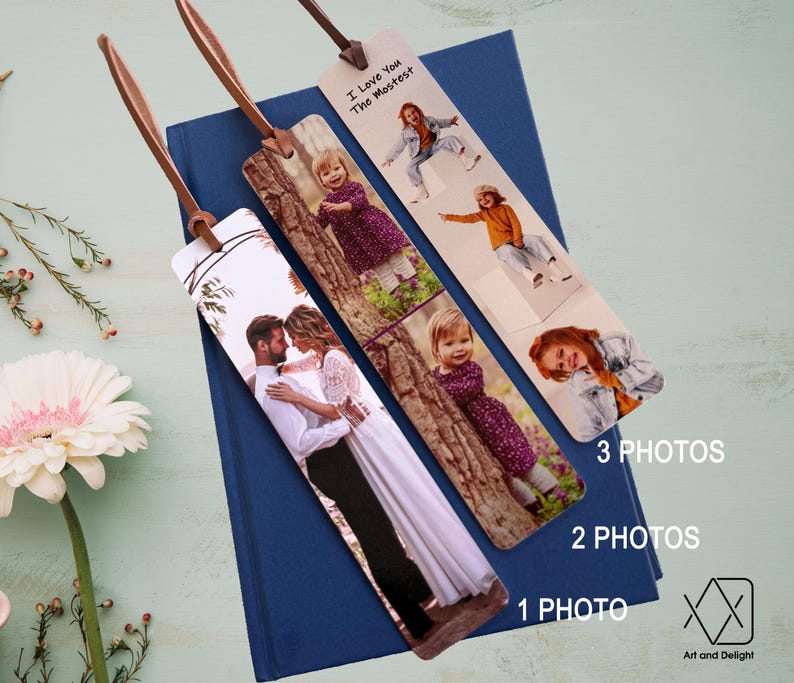 May include: Three personalized bookmarks with different photo layouts. The bookmarks are made of wood and have a brown leather strap. The text on the bookmark reads "I love you the mostest".