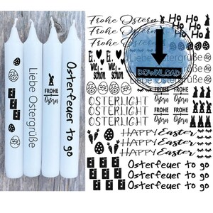 Könnte beinhalten: Drei weiße Kerzen mit schwarzem Text. Der Text auf den Kerzen lautet "Liebe Ostergrüße", "Frohe Ostern" und "Osterfeuer to go".
