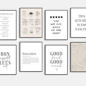 May include: Eight framed art prints with black frames, each displaying kitchen-related designs and text. The prints include phrases such as "Kitchen Rules," illustrations of coffee equipment, and statements like "Chef was cute" and "Good food, good mood."