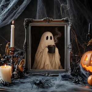 May include: A framed print featuring a white ghost draped in a sheet holding a steaming black mug. The ornate black frame sits among white candles, black plastic spiders, a carved orange jack-o'-lantern, and artificial spider webs.