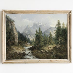 May include: A framed oil painting depicting a mountain landscape with a river flowing through a forest. The painting features a small cabin in the distance and a cloudy sky.