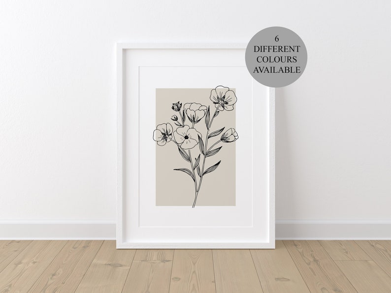 Pode incluir: Uma impress&atilde;o emoldurada de um desenho em preto e branco de um buqu&ecirc; de flores sobre um fundo bege. O texto "6 DIFFERENT COLOURS AVAILABLE" est&aacute; em um c&iacute;rculo na parte superior direita da imagem.