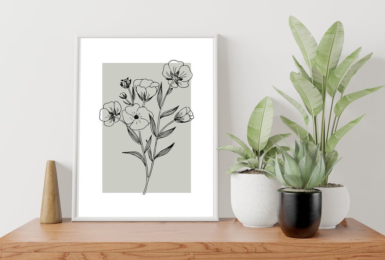 Pode incluir: Um desenho de linha preto e branco emoldurado de um buqu&ecirc; de flores em um fundo cinza claro.