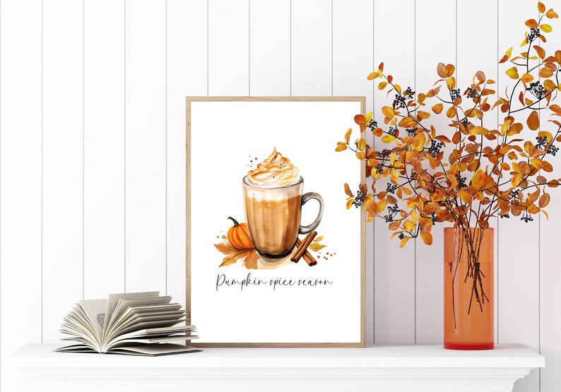 May include: A watercolor illustration of a pumpkin spice latte with whipped cream and cinnamon sticks. The text "Pumpkin Spice Season" is written below the latte.