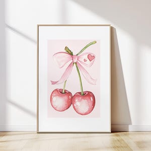 K&ouml;nnte beinhalten: Zwei rosa Kirschen mit einer rosa Schleife um die Stiele. Die Kirschen befinden sich auf einem rosa Hintergrund.