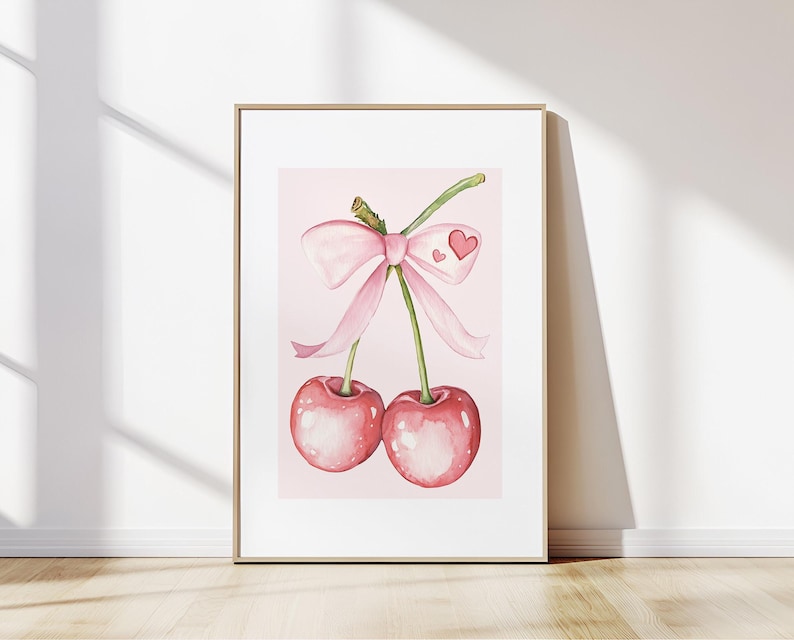 K&ouml;nnte beinhalten: Zwei rosa Kirschen mit einer rosa Schleife um die Stiele. Die Kirschen befinden sich auf einem rosa Hintergrund.