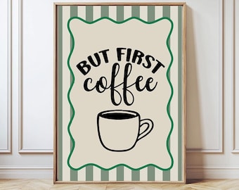 May include: Framed wall art with the text "BUT FIRST coffee" in black script above a black coffee cup illustration. The artwork has a beige background with a green wavy border and is set against a green and white striped background.