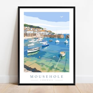 May include: A framed art print depicting Mousehole, Cornwall, with boats in a harbour and buildings in the background. The artwork uses a blue and green colour scheme, with a clear sky and a seagull. The text "MOUSEHOLE CORNWALL" is at the bottom.