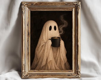 May include: A framed wall art print featuring a beige ghost figure draped in fabric, holding a steaming black mug against a dark background. The artwork is encased in an ornate, metallic gold-toned rectangular frame with intricate detailing.