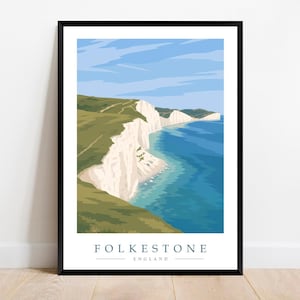 May include: A framed art print depicting the Folkestone coastline, showcasing white cliffs, green hills, and the sea under a blue sky. The print includes the text "FOLKESTONE ENGLAND".