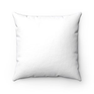 May include: A white square pillow with a smooth, soft fabric surface.