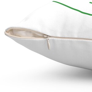 May include: A white pillow with a zipper closure. The zipper is visible and is open. The pillow is made of a soft, white fabric.