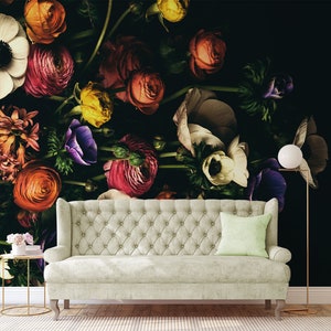 May include: A white sofa with a light green cushion sits in front of a black wall with a floral mural. The mural features a variety of flowers in shades of pink, red, white, purple, and yellow.