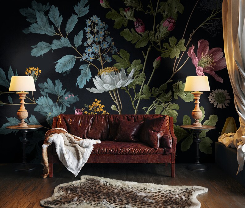 May include: A brown leather sofa with a white throw blanket sits in front of a dark wall with a large floral mural featuring white, pink, and blue flowers.