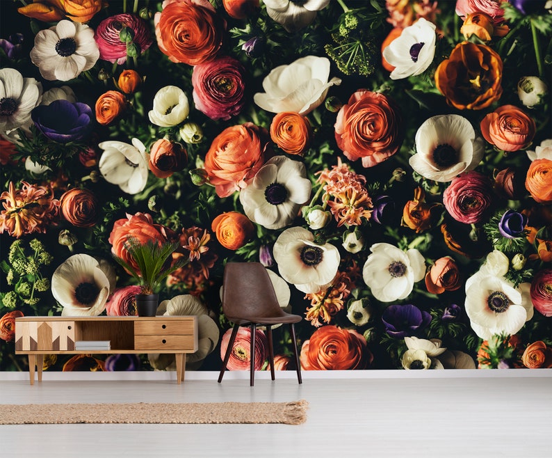 May include: A close-up image of a floral wall mural featuring a variety of white, pink, and orange flowers. The flowers are arranged in a random pattern and create a beautiful and vibrant design.