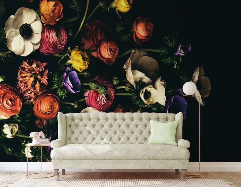 May include: A white sofa with a light green cushion sits in front of a black wall with a floral mural. The mural features a variety of flowers in shades of pink, red, white, purple, and yellow.