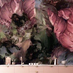 May include: A pink kitchen cabinet with gold handles. The cabinet is in front of a wall with a large abstract floral painting in shades of pink, green, and brown.
