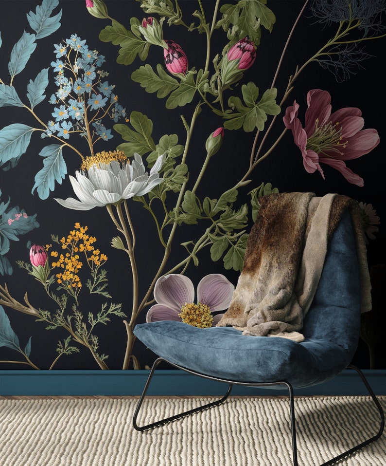 May include: A blue velvet armchair with a brown faux fur throw sits in front of a black wall with a floral wallpaper featuring pink, white, and yellow flowers.