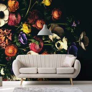 May include: A white sofa with a floral wallpaper featuring a variety of colourful flowers, including pink, red, orange, yellow, and purple.
