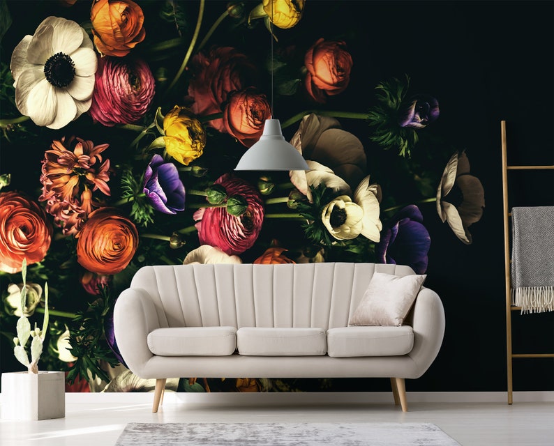 May include: A white sofa with a floral wallpaper featuring a variety of colourful flowers, including pink, red, orange, yellow, and purple.