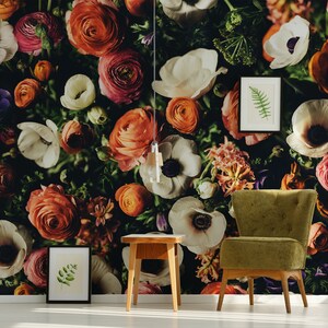 May include: A floral wallpaper with a variety of flowers in shades of red, orange, pink, white, and purple. A green armchair and a wooden side table are in front of the wallpaper.