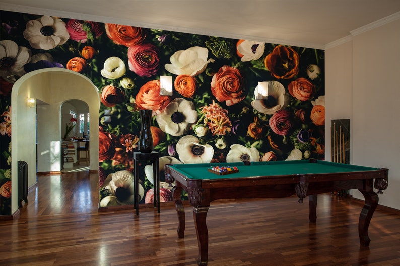 May include: A dark green wall with a floral wallpaper featuring a variety of colorful flowers, including white, pink, red, and orange. A pool table with a green felt top is in the foreground.