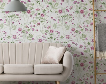 May include: A white sofa with a light pink pillow sits in front of a wall with a floral wallpaper pattern. The wallpaper features pink flowers and green leaves on a white background.