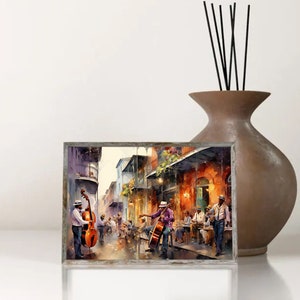 Op de afbeelding: Een aquarel schilderij van een straatbeeld in New Orleans met muzikanten die contrabassen bespelen. De straat is omzoomd met kleurrijke gebouwen en mensen zitten aan tafels buiten caf&eacute;s.