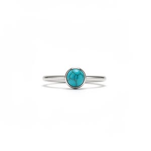 May include: A silver ring with a round, turquoise stone. The ring has a thin band and a simple, elegant design. The turquoise stone is a bright, robin's egg blue color.