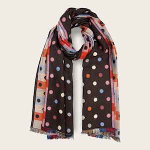 May include: A brown scarf with a white, pink, blue and orange polka dot pattern. The scarf has a fringe border.