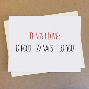 May include: White card with black text that reads "Things I Love: 1) Food 2) Naps 3) You". The text "Things I Love" is in red.