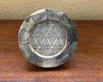 Small round blue and grey frame holds  a 2 1/2 inch photo