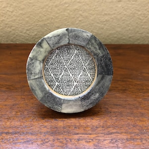 Small round blue and grey frame holds  a 2 1/2 inch photo