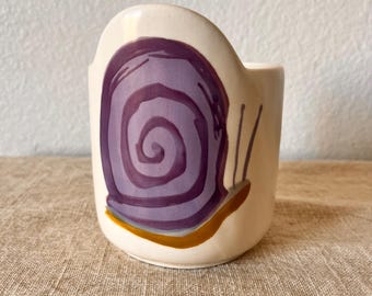 4” cream colored planter with snail painted on it.