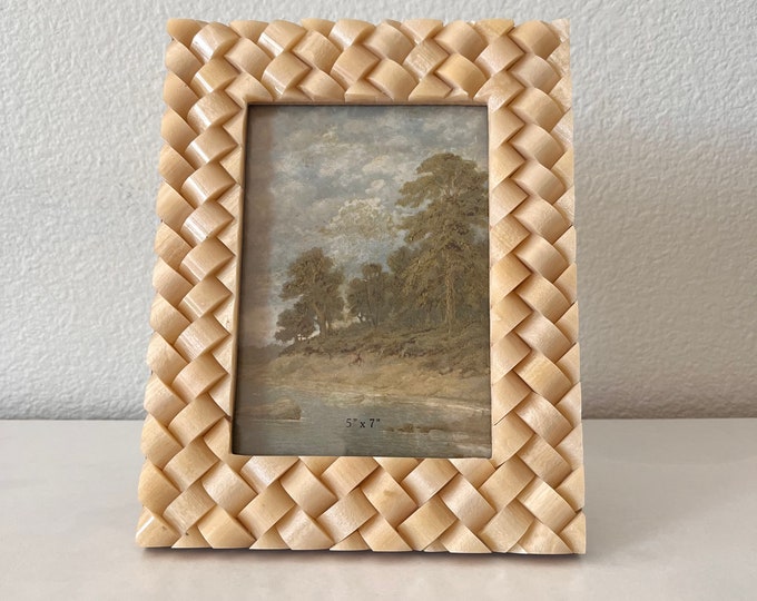 Woven resin frame 9 1/2 x 7 1/2 frame holds approximately a 5x7 photo can stand both horizontal or vertical