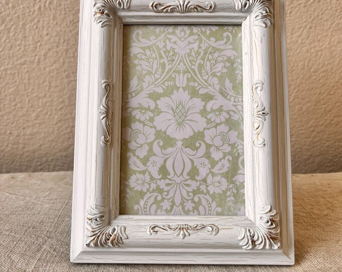 Vintage white 8" x 6” frame with ornate detailing holds approximately eight 3 1/2x 5 1/2" photo