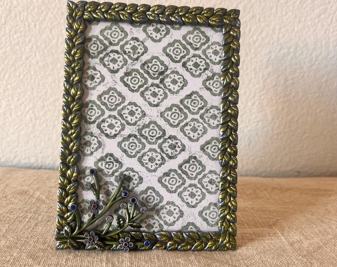 Vintage 6 1/2” x 4 1/2” frame detailed with leafs and floral rhinestone design holds a 3 1/2" by 5 1/2" image.