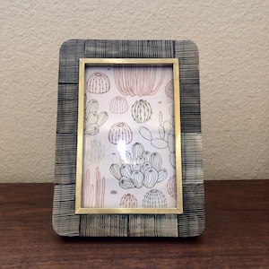 Vintage style navy textured wood frame with brass edge detail holds a 4x6 image