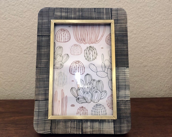 Vintage style navy textured wood frame with brass edge detail holds a 4x6 image