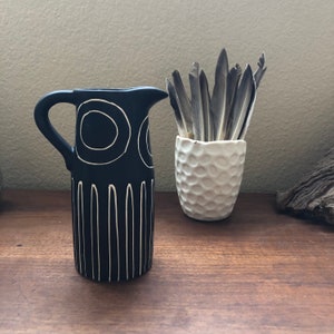 Black Pitcher with devised white geometric design